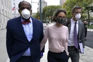 Clzre Bronfman, with her attorneys, walk into court for her sentencing hearing. She would not walk out