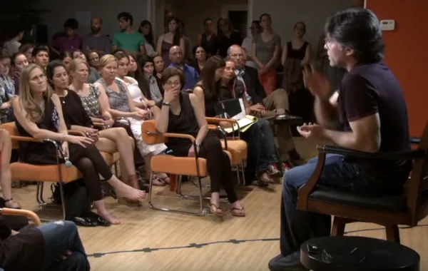 Keith Raniere talks to a room full of adoring women, most, if not all of whom had sexual relations with him. Raniere kept them all skinny; and obedient and took whichever of the women he wanted, when he wanted, and never hesitated to steal his male disciples wives or girlfriends when it suited him. On top of that, he had his woman find him other women and worse, little girls. He was a genuine sex addict and a true pervert. Most of Raniere's followers were women but he attracted a type of beta male, like Edgar and his brother Omar - who could sit back and watch Raniere take charge of their women and even brand a wife's pussy with his initials - and still regard him as a living god.
