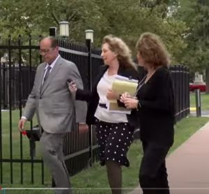 Attorney Nickola Cunha [center] walks into court with KAren Riordan. Investigative reporter Wayne Dolcefino, who has been covering the case, is on their left.