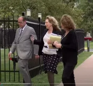 Attorney Nickola Cunha [center] walks into court with KAren Riordan. Investigative reporter Wayne Dolcefino, who has been covering the case, is on their left.