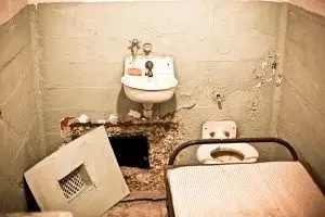 Prison cell in Alcatraz witha hole in the wall, San Francisco. Grainy due to high iso level.