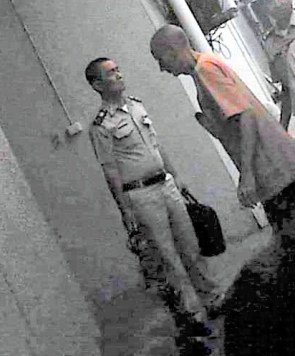 Roger Clark is on his way into court in Thailand. He was subsequently extradited to the US.