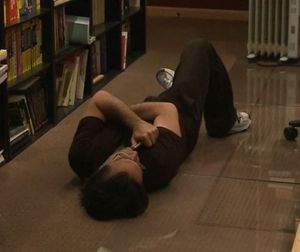 Keith Alan Raniere - poses for the camera while lying on the floor.