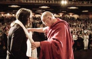 The Dalai Lama gives Keith Raniere a white scarf symbolizing purity before an audience of around 2700 in Albany NY in May 2009.