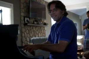 Keith Raniere playing piano at Nancy Salzman's house