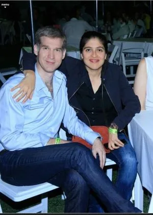 Ms. Garza with her husband Omar Boone who also has a green sash. Ms. Garza has Keith Raniere's initials one inch from her vagina as a symbol of her obedience to Mr. Raniere.