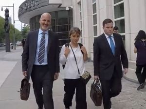 Allison Mack leaves the federal courthouse in Brooklyn following one of her appearances there with her attorneys. She faces charges of sex trafficking and racketeering.