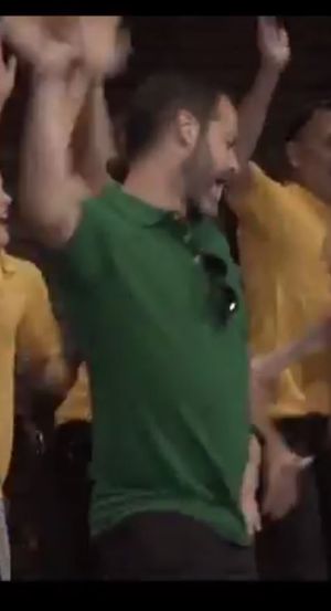 Emiliano dances on stage at an all-ESPian gathering during V-Week. His green shirt corresponds to his rank in ESP.