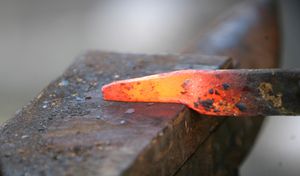 The hot iron burns initials and leaves a lasting scar.