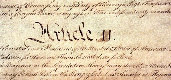 Close-up of an old parchment page with ornate calligraphic handwriting, featuring a decorative heading that appears as 'WriTe II' (historic document style).