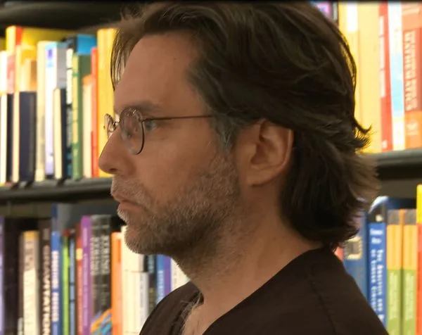 Keith Raniere in his library at 8 Hale Dr. Half Moon NY.