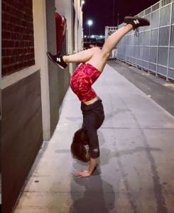 Dr. Danielle Roberts does a special pose for her Vanguard in front of the MDC prison.