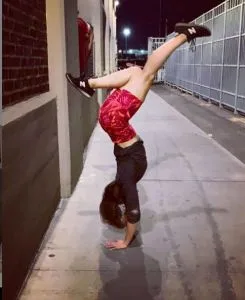 Dr. Danielle Roberts does a special pose for her Vanguard in front of the MDC prison.