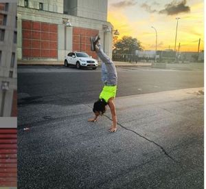 Dr. Roberts does a handstand in front of the detention center where Keith Raniere was detained.