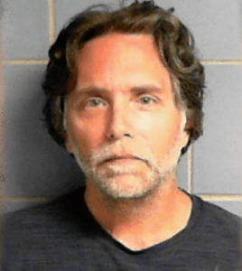 Keith Raniere's mugshot at the Brooklyn Metropolitan Detention Center, taken in 2018.