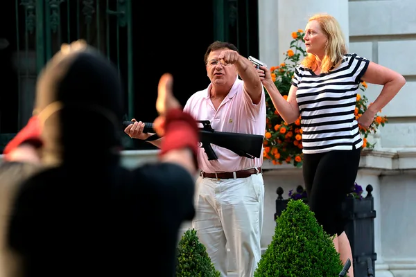 Were the McCluskeys' defending their home or trying to intimidate the 100 or peaceful protestors who merely knocked down a gate and were trespassing on private property?