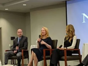 Barbara Bouchey [c] discusses her experiences in Nxivm at a forum sponsored by the Albany Times Union. Brendan Lyons, senior investigative editor for the Times Union [l] and Catherine Oxenberg [r].