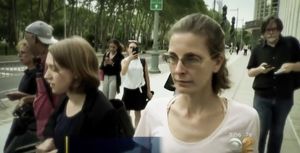 Clare Bronfman leaves court after being charged criminally in a federal case.