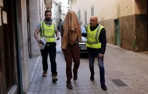 Fredy Escobar escorted by police.