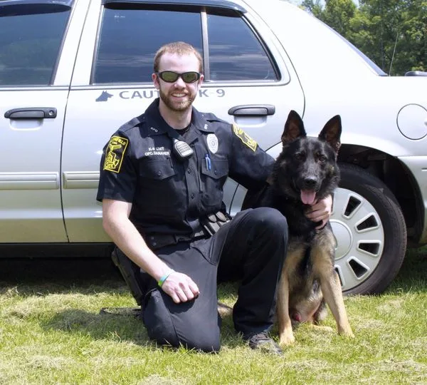 K-9 Officer Brenden Danaher (left) -- found his bark was loud, but a woman put the bite on him when she won $1.5 million from the CT taxpayers after the K9 cop hot caught lying to a judge.
