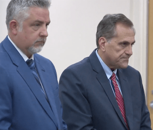 Attorney James Nobles stands beside Steve Pigeon as he takes a plea.