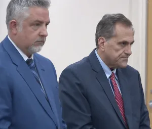 Attorney James Nobles stands beside Steve Pigeon as he takes a plea.