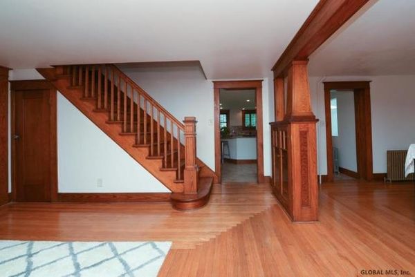 "The interior features gorgeous woodwork trim and hardwoods." - realtor.com / Sarah Edmondson writes in her book that on the night she was branded, she was led down these stairs blindfolded, holding the hand of her master, Lauren Salzman.
