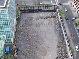 The size of the hole can be seen by observing the cars on the street.