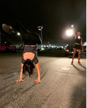 Dr, Danielle Roberts does a handstand in front of MDC.