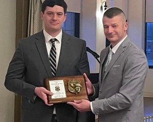 Nick Lund receives an award from Andy Thompson