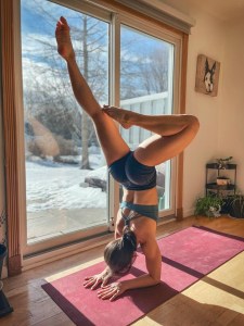 Danielle Roberts doing a hand stand, as part of her yoga practice.