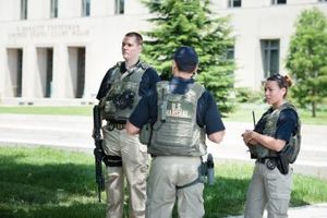 Agents of the U.S. Marshal Service outside a Federal Courthouse.