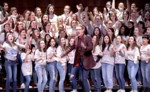 Deke Sharon leads a chorus of a capella singers.