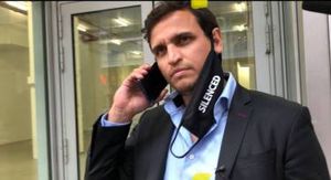 Eduardo Asunsolo on the phone, outside of Moira Penza's office building.
