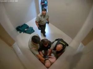 Several officers restrain Joshua McLemore on July 20, 2021. [Courtesy McLemore estate]