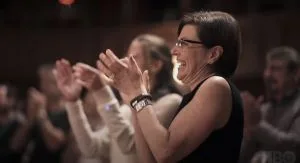 Nancy applauds the great one.