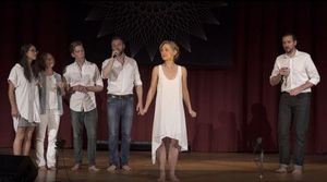 Allison Mack, wearing the same white dress, sings on her Vanguard's birthday, August 26, 2016. Her Vanguard is in the audience.