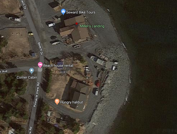 Where the Google aerial map reads "Beach" is just north on the road from where Kristin Snyder's pickup truck was left. The word "House" signifies an area about where the shed is. The kayak, if not taken from the shed but taken from the yard, would have been just south of the shed. The Millers' home is where the word "Halibut" is. In addition to Miller's Landing, the Millers own and operate a food stand where they cook fresh halibut and other fish from the waters.