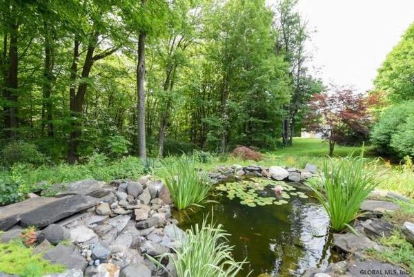 The grounds. "Walk around and enjoy the fresh flowers, sit on the back porch and overlook the gazebo and koi pond, detached two-car garage with new concrete floor, heated barn for workshop, studio or home office/business." - realtor.com